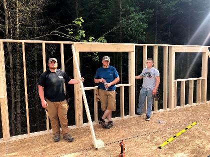 Land and Camp Crew Taking Break Building Customer Cabin 