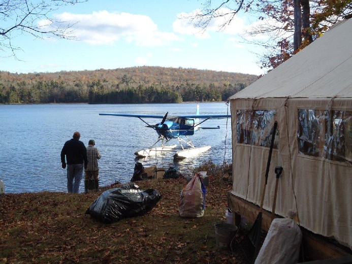 image of family at camp with seaplane 